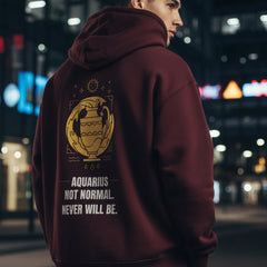 Maroon hoodie with yellow Aquarius zodiac design and text on a white background