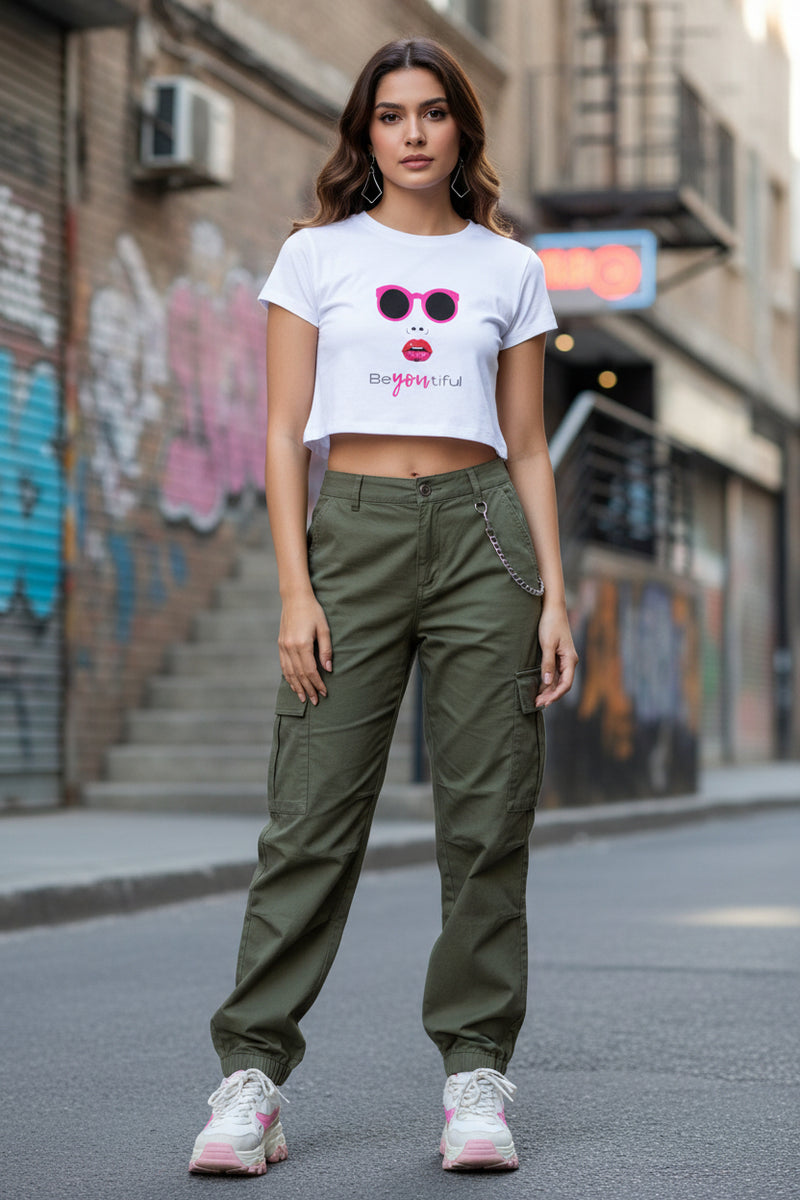 Woman wearing a white t-shirt with sunglasses and lipstick graphic and denim shorts on a white background