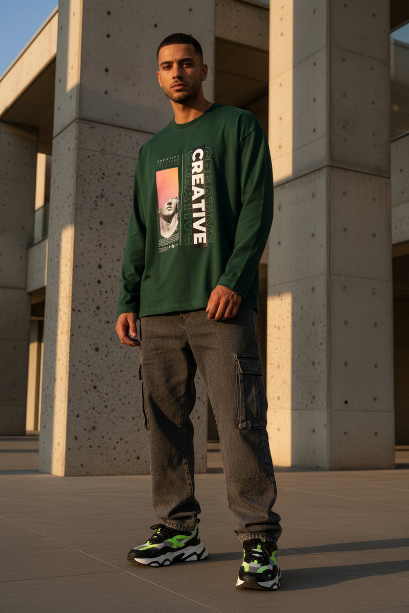 Green long-sleeve shirt with artistic design and 'CREATIVE' text on a white background