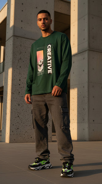Green long-sleeve shirt with artistic design and 'CREATIVE' text on a white background