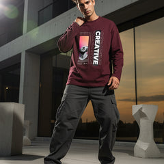 Maroon long-sleeve shirt with artistic design and 'CREATIVE' text on a white background