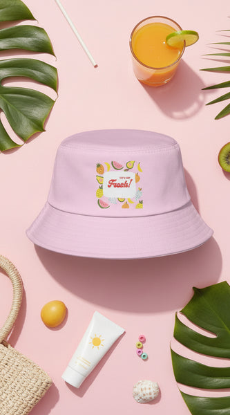 Pink bucket hat with fruit-themed design and text on a white background