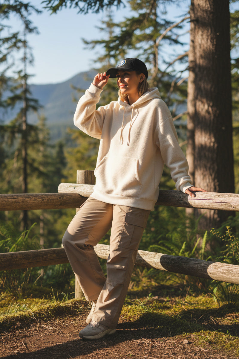 Black cap with 'Adventure into the Wild' logo on a light gray background