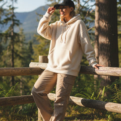 Black cap with 'Adventure into the Wild' logo on a light gray background