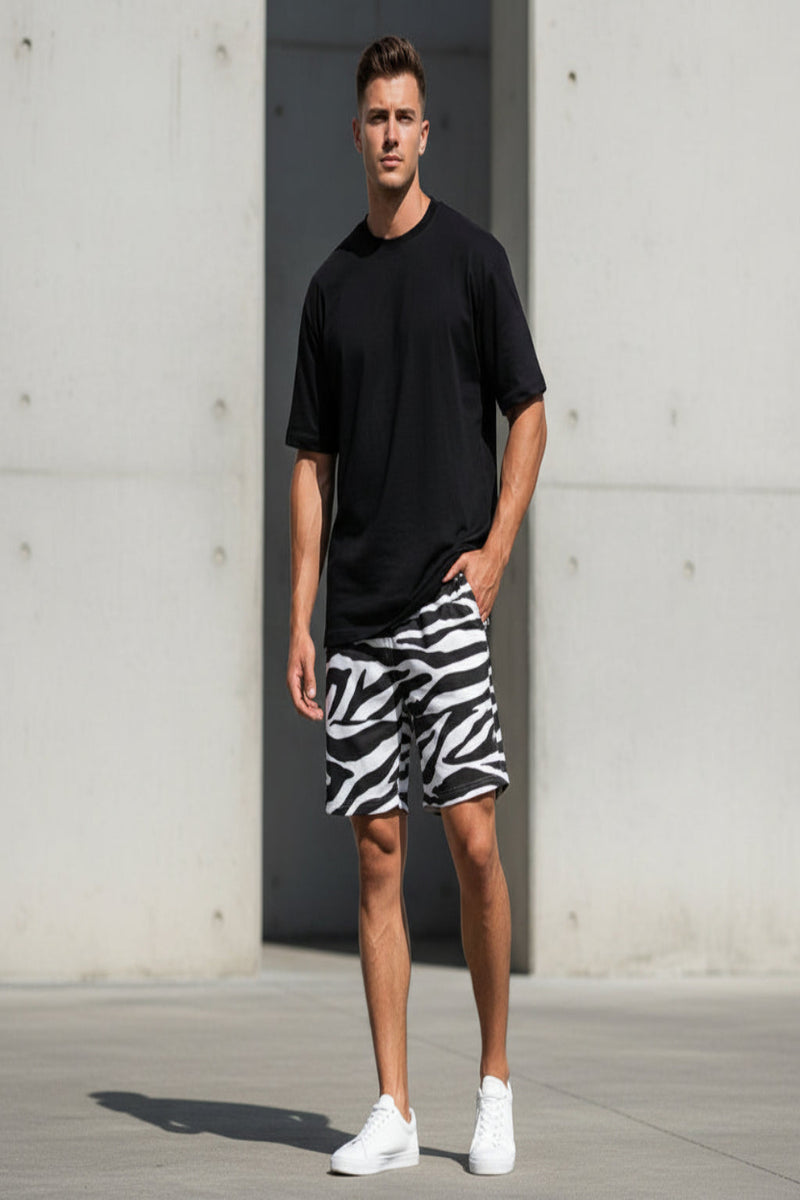 Person wearing zebra print shorts and a blue top, holding a soccer ball.