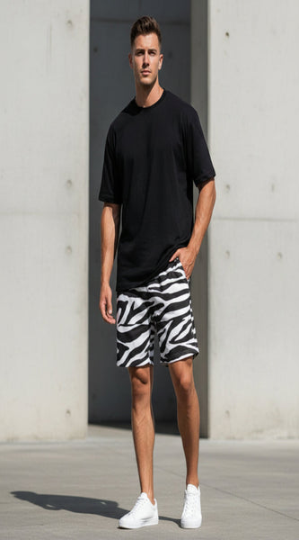Person wearing zebra print shorts and a blue top, holding a soccer ball.
