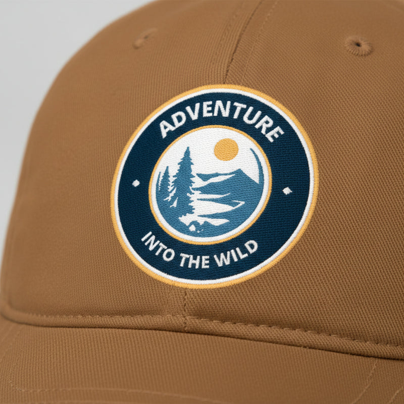 Brown cap with 'Adventure into the Wild' logo on a light gray background