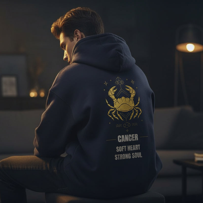 Navy blue hoodie with yellow crab design and text on the back against a light gray background