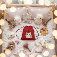 Red drawstring bag with a cat illustration and text on a light gray background