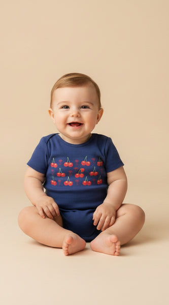Navy blue baby onesie with red cherry design and text on a white background