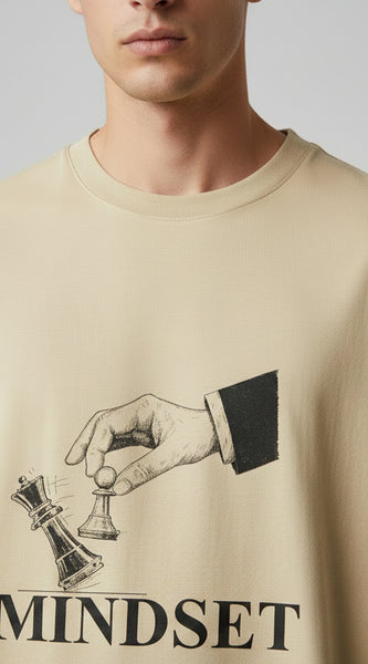 Beige t-shirt with a graphic design and the word 'MINDSET' on a white background