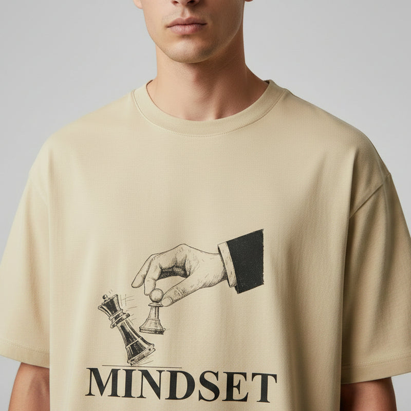 Beige t-shirt with a graphic design and the word 'MINDSET' on a white background