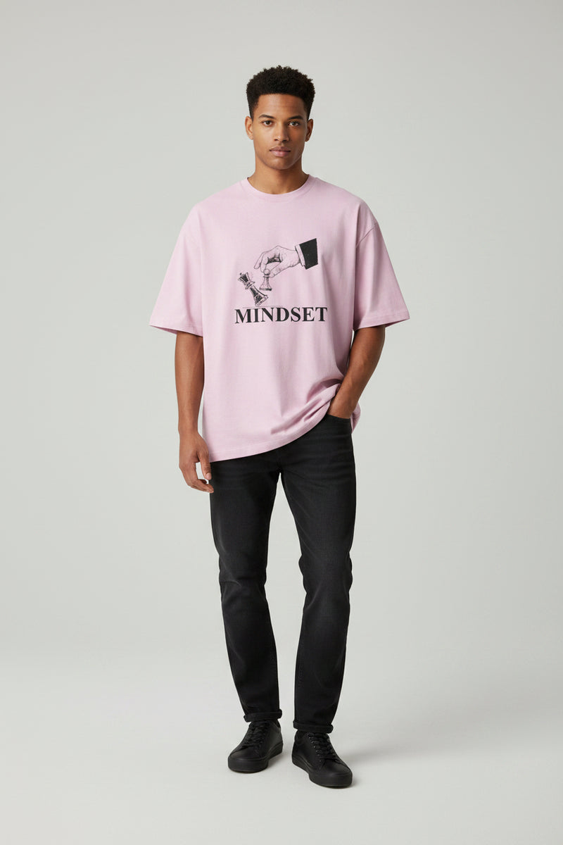 Pink t-shirt with a graphic and 'MINDSET' text on a white background