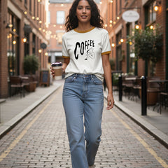 White t-shirt with brown trim featuring the word 'COFFEE' and a graphic of a person holding a coffee cup.