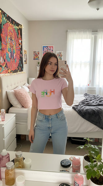 Pink t-shirt with 'HOPE' in colorful letters on a white background