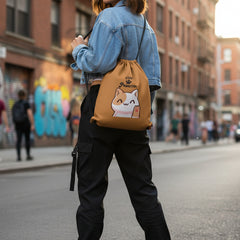 Brown drawstring bag with a cat illustration and 'Stay Pawsitive' text on a light gray background.
