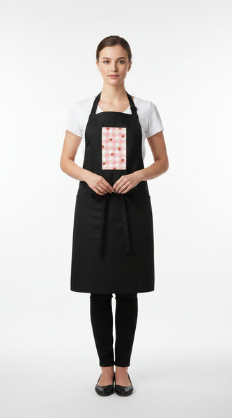 Woman wearing a black apron with a red and white pattern on a white background
