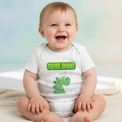 White baby onesie with green dinosaur design and 'Cute Dino' text on a white background