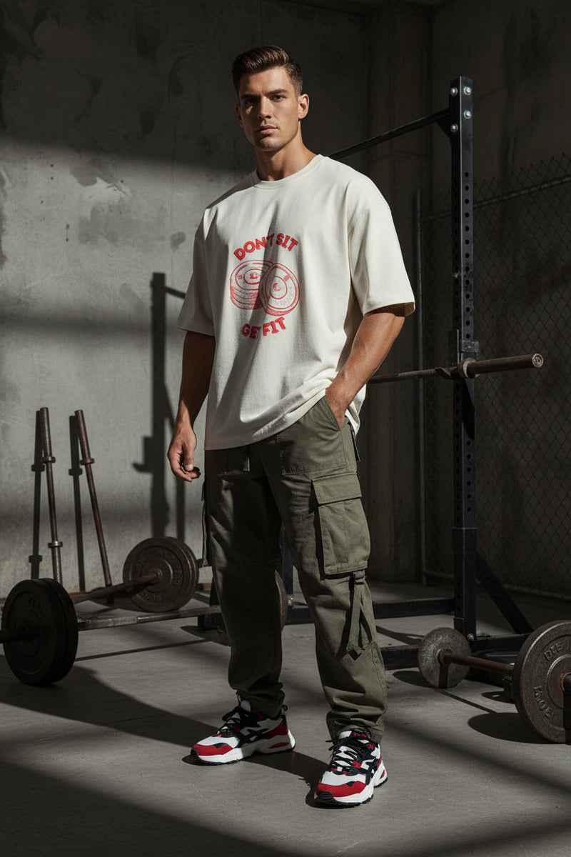 Beige t-shirt with red graphic and text on a light gray background