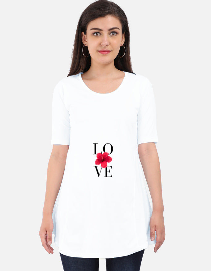 Woman wearing a white Maternity Dress  with 'LOVE' and a red flower design on a plain background