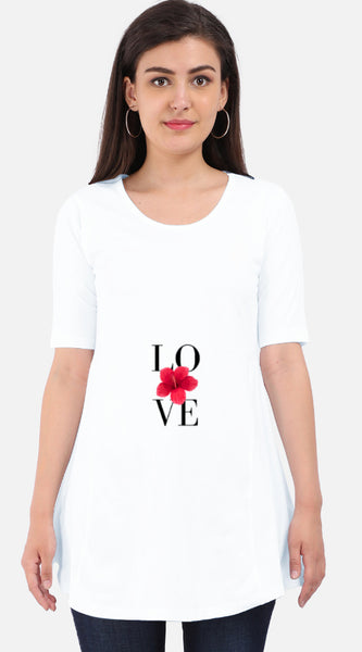 Woman wearing a white Maternity Dress  with 'LOVE' and a red flower design on a plain background