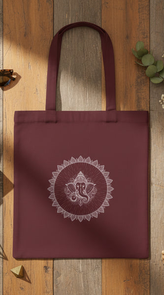 Maroon tote bag with 'No Pain, Just Gain' text held by a person against a gray background