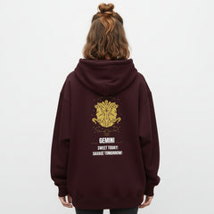 Maroon hoodie with yellow astrological design and text on a white background