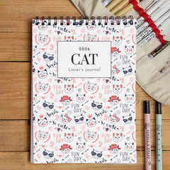 2026 cat lover's journal with stationery items on a wooden surface