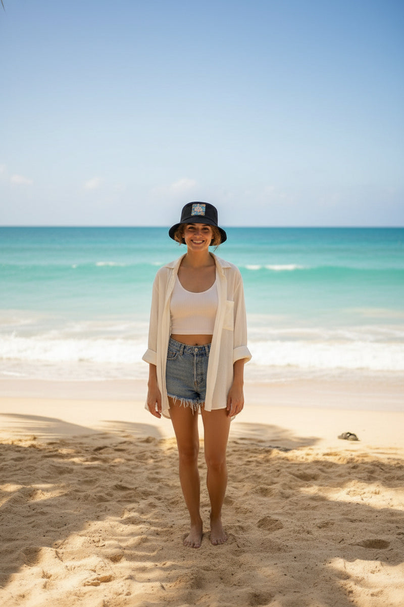Black bucket hat with a colorful pineapple design on a white background
