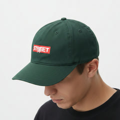 Green with a red and white logo on a light gray background