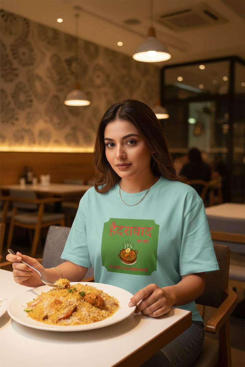 Light blue t-shirt with a green graphic and text on a white background