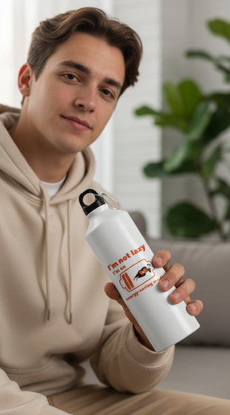 White water bottle with humorous design and text on a blurred green outdoor background