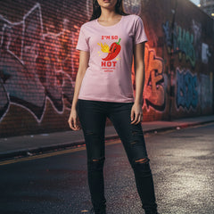 Woman wearing a pink t-shirt with a red pepper graphic and text.