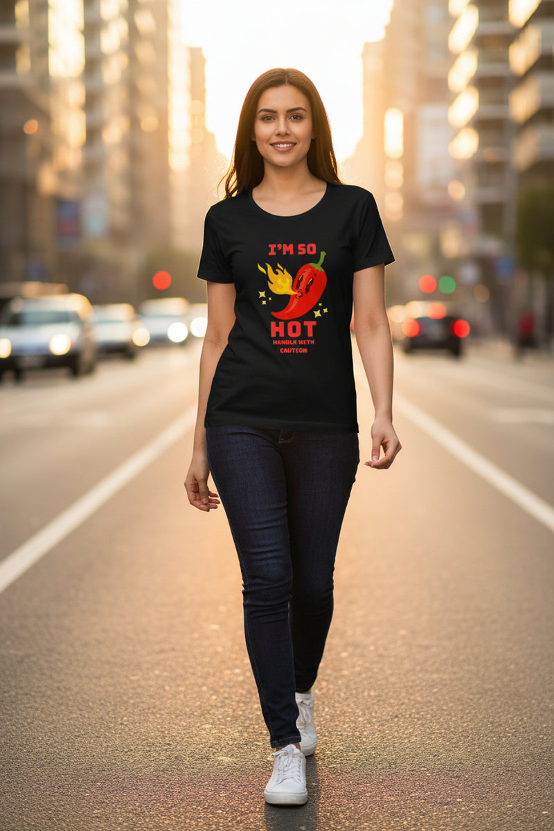 Woman wearing a black t-shirt with a red pepper graphic and text.