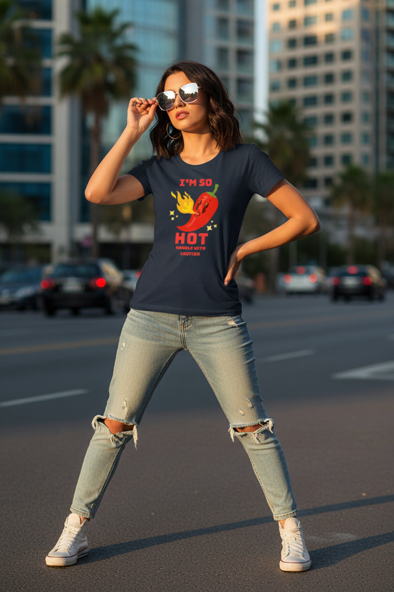 Woman wearing a blue t-shirt with a red pepper graphic and text.