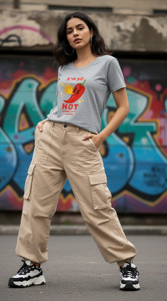 Woman wearing a gray t-shirt with a red pepper graphic and text.