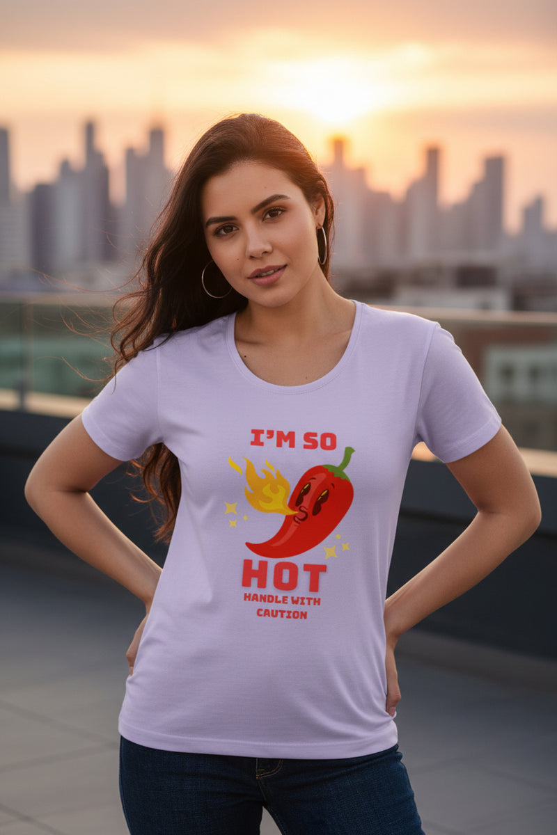 Woman wearing a light purple t-shirt with a red pepper graphic and text.