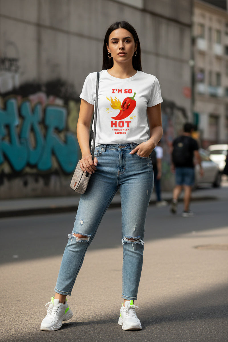 Woman wearing a white t-shirt with a red pepper graphic and text.