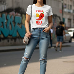 Woman wearing a white t-shirt with a red pepper graphic and text.