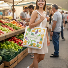 Tote bag with vegetable design and text 'in to ORGANIC' on a white background