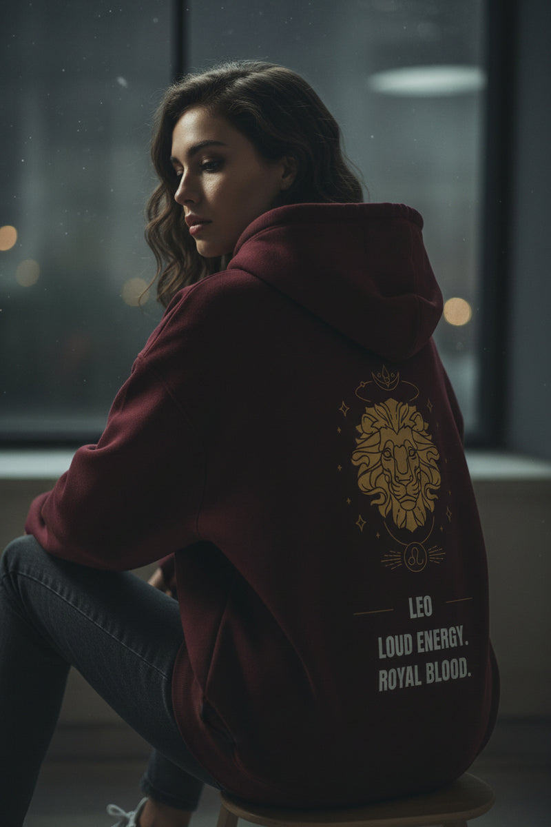 Maroon hoodie with gold lion design and text on a white background