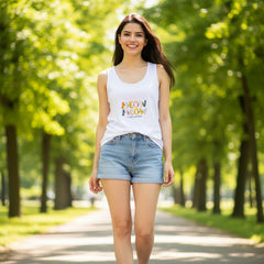 Woman wearing a white sleeveless shirt with colorful text design on a white background