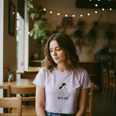 Lavender t-shirt with graphic design and text on a white background
