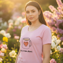 Woman wearing a baby pink t-shirt with a coffee cup graphic and text on a white background