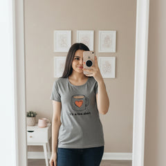 Woman wearing a gray t-shirt with a coffee mug graphic and text.