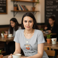 Woman wearing a gray t-shirt with a heart design and text on a white background