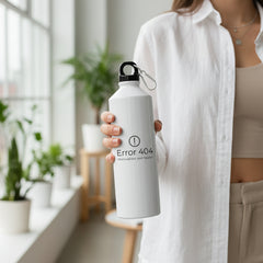 White water bottle with geometric design on a light surface with greenery in the background