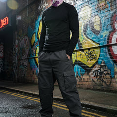 Person wearing a colorful balaclava with leopard print design on a white background