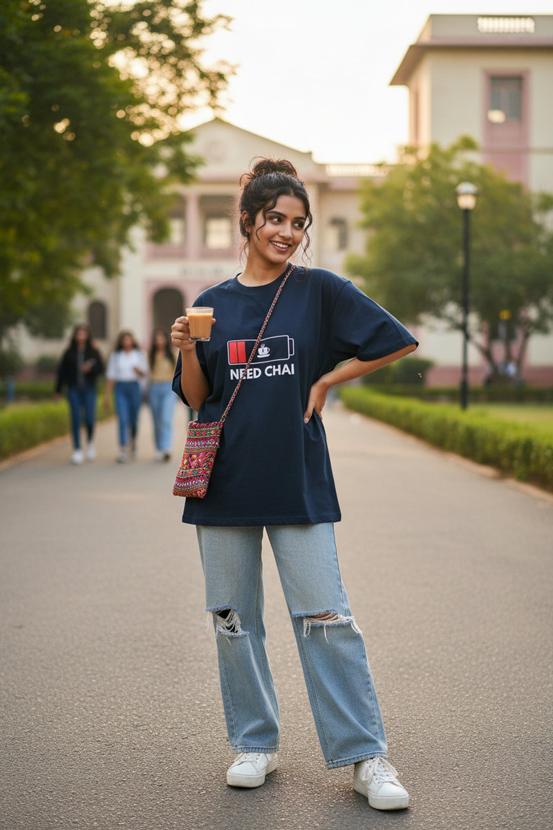 Blue  t-shirt with a graphic design and text 'NEED CHAI' on a white background