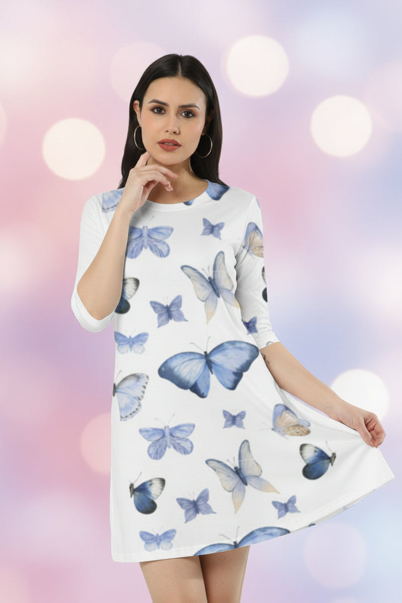 Woman wearing a white dress with blue butterfly patterns on a white background